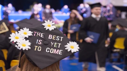 毕业典礼上的一顶帽子,上面写着“最好的尚未到来”